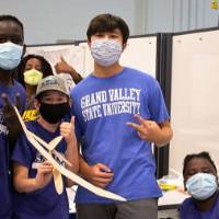 Students pose with their airplane projects